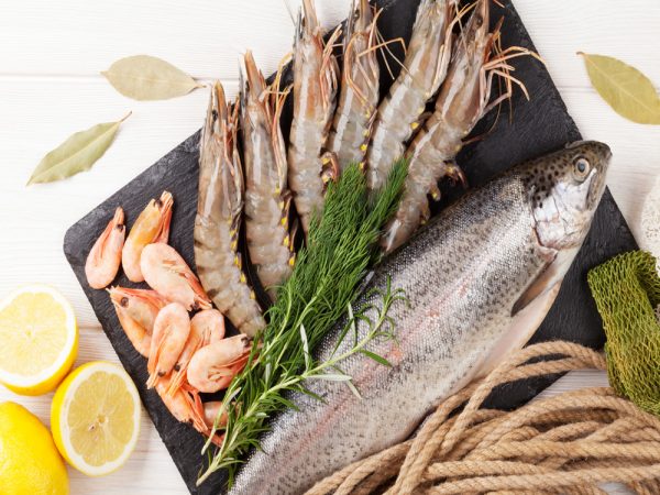 Fresh raw sea food with spices Fresh raw sea food with spices on wooden table background. Top view
